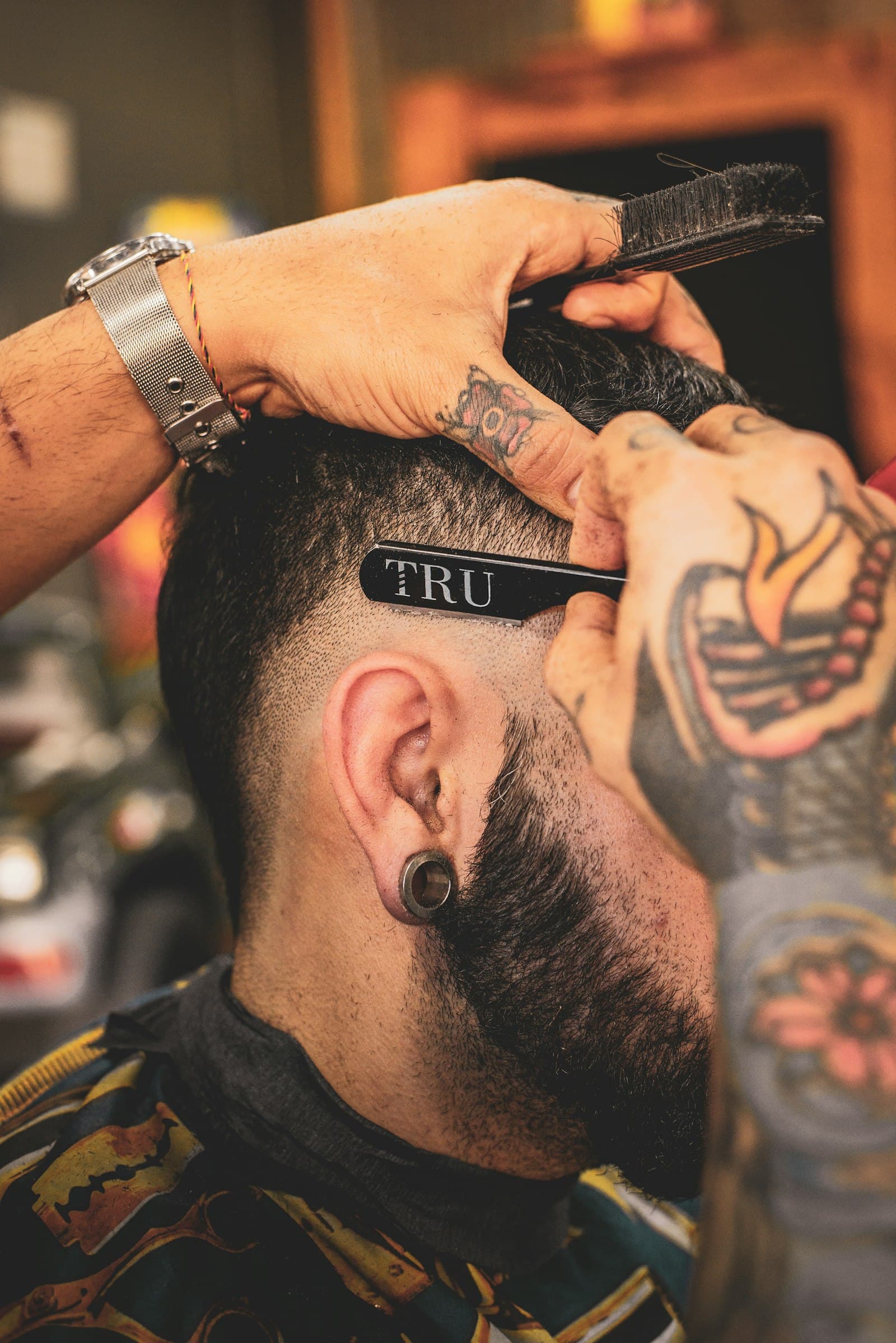 Barber refining a fade with a razor